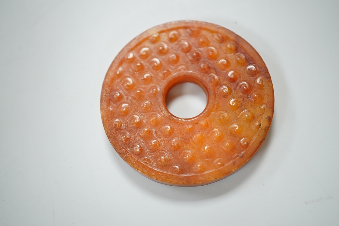 A Chinese pottery jug, two hardstone discs and a metal seal. Jug 17.5cm high